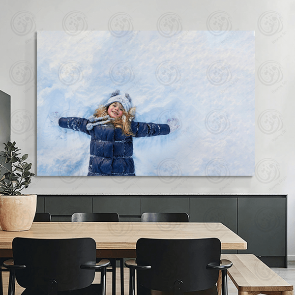 A beautiful little girl in a jacket playing in a snowy winter garden - E1PR-11566
